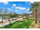 Scenic exterior view from a balcony overlooking lush lawns and a serene walking path near a tranquil lake at 945 E Playa Del Norte Dr # 5005, Tempe, AZ 85288