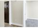 Hallway showing the transition between tile flooring and carpet with brown cabinets on one side at 945 E Playa Del Norte Dr # 5005, Tempe, AZ 85288
