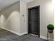 Hallway showing unit's front door with modern paint colors and dark carpeting at 945 E Playa Del Norte Dr # 5005, Tempe, AZ 85288