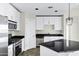 Bright kitchen featuring stainless appliances, granite countertops, and designer pendant lighting at 945 E Playa Del Norte Dr # 5005, Tempe, AZ 85288