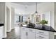 Modern kitchen with black granite countertops, white cabinets, and stainless steel appliances at 945 E Playa Del Norte Dr # 5005, Tempe, AZ 85288