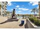 A luxurious outdoor pool area featuring a fireplace, comfortable lounge chairs, and lush landscaping at 945 E Playa Del Norte Dr # 5005, Tempe, AZ 85288