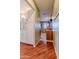 Hallway view with wood-look floors leading to a bedroom and bathroom at 9502 W Cedar Hill N Cir, Sun City, AZ 85351