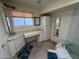 Bathroom with a large vanity area, cabinets and a window at 10013 W Alabama Ave, Sun City, AZ 85351