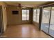 Versatile sunroom with laminate flooring, bright natural light, and access to the outdoors at 10013 W Alabama Ave, Sun City, AZ 85351