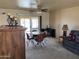 Inviting dining area with a round table, carpet, and seamless flow to the living space at 10013 W Alabama Ave, Sun City, AZ 85351