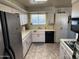 Well-lit kitchen with ample cabinet space, laminate countertops, and modern stainless steel appliances at 10013 W Alabama Ave, Sun City, AZ 85351