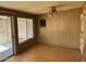 Cozy room featuring wood paneling, dart board and outdoor view at 10013 W Alabama Ave, Sun City, AZ 85351