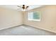 A bright bedroom featuring carpet, a ceiling fan, and a window at 10025 W Alabama Ave, Sun City, AZ 85351