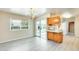 Bright dining room featuring a modern chandelier, gray wood-look flooring, and natural light at 10025 W Alabama Ave, Sun City, AZ 85351