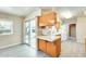 Updated kitchen with a breakfast bar, vinyl flooring, plenty of natural light, and direct access to the patio at 10025 W Alabama Ave, Sun City, AZ 85351