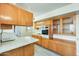 Functional kitchen offering ample cabinet space, a breakfast bar, and essential appliances at 10025 W Alabama Ave, Sun City, AZ 85351