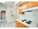 Cozy kitchen featuring white appliances, tile countertops, and wood-look flooring at 10025 W Alabama Ave, Sun City, AZ 85351