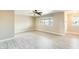 Well-lit living room featuring new light grey vinyl flooring, large windows, and a ceiling fan at 10025 W Alabama Ave, Sun City, AZ 85351