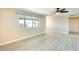 Inviting living room boasts new light grey vinyl flooring, a ceiling fan, and natural light at 10025 W Alabama Ave, Sun City, AZ 85351