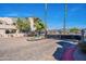 Gated community entrance with lush landscaping and mature palm trees and cobblestone streets at 10115 E Mountain View Rd # 2042, Scottsdale, AZ 85258