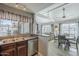 Kitchen with sink, view to the living room, and stainless steel dishwasher at 10115 E Mountain View Rd # 2042, Scottsdale, AZ 85258