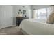 Spacious bedroom with a large window, soft carpet, and a black dresser at 10115 E Mountain View Rd # 2042, Scottsdale, AZ 85258