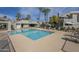 Community pool with ample lounge seating, mature palm trees and adjacent clubhouse at 10115 E Mountain View Rd # 2042, Scottsdale, AZ 85258