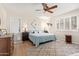 Bright bedroom features a ceiling fan, light color palette, and plantation shutters at 10127 E Minnesota Ave, Sun Lakes, AZ 85248