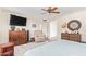 Large bedroom with ceiling fan, dresser, tv, and lots of natural light at 10127 E Minnesota Ave, Sun Lakes, AZ 85248