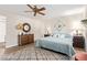 Comfortable bedroom featuring a ceiling fan, soft blue quilt, and wood-look flooring at 10127 E Minnesota Ave, Sun Lakes, AZ 85248