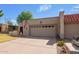 Charming home with a two-car garage, American flag, and desert landscaping at 10127 E Minnesota Ave, Sun Lakes, AZ 85248