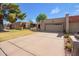 Charming home with a two-car garage, American flag, and desert landscaping at 10127 E Minnesota Ave, Sun Lakes, AZ 85248