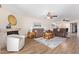 Spacious living room with fireplace, ceiling fans, and wood-look flooring at 10127 E Minnesota Ave, Sun Lakes, AZ 85248