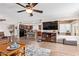 Spacious living room featuring an open floor plan to the kitchen and modern ceiling fan at 10127 E Minnesota Ave, Sun Lakes, AZ 85248