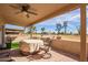 Covered patio featuring a ceiling fan, brick flooring, and views of the green golf course at 10127 E Minnesota Ave, Sun Lakes, AZ 85248