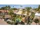 Scenic aerial shot of the home featuring a pool, lush landscaping, and a tile roof at 10337 E Michigan Ave, Sun Lakes, AZ 85248