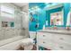 Bright bathroom with turquoise walls, glass shower door, and granite vanity at 10337 E Michigan Ave, Sun Lakes, AZ 85248