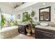 Bathroom featuring double sink vanity, a soaking tub, plants and a neutral color palette at 10337 E Michigan Ave, Sun Lakes, AZ 85248