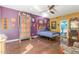 Spacious bedroom showcasing colorful walls, wood floors, and a ceiling fan at 10337 E Michigan Ave, Sun Lakes, AZ 85248