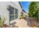 Side exterior view showcasing a home's private entrance with a sliding door and landscaped pathway at 10337 E Michigan Ave, Sun Lakes, AZ 85248