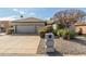 Home exterior featuring well-kept landscaping, a concrete driveway, and an attached two-car garage at 10337 E Michigan Ave, Sun Lakes, AZ 85248