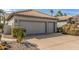 Spacious two car garage, concrete driveway and mature landscaping at 10337 E Michigan Ave, Sun Lakes, AZ 85248