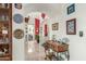 Hallway view featuring tiled floors, arched doorways, decorative dishware and a wood console table at 10337 E Michigan Ave, Sun Lakes, AZ 85248