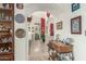 Hallway view featuring tiled floors, arched doorways, decorative dishware and a wood console table at 10337 E Michigan Ave, Sun Lakes, AZ 85248