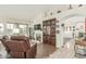 Open living room featuring tile flooring, a fireplace with a display niche, and shuttered windows at 10337 E Michigan Ave, Sun Lakes, AZ 85248