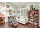 Bright living room featuring hardwood floors, white couch, desk and shelf at 10337 E Michigan Ave, Sun Lakes, AZ 85248