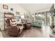 Bright living room with tile floors, comfortable seating, and large windows offering plenty of natural light at 10337 E Michigan Ave, Sun Lakes, AZ 85248