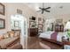 Main bedroom showing hardwood floors, vaulted ceilings, and entrance to the ensuite at 10337 E Michigan Ave, Sun Lakes, AZ 85248