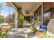 Covered patio with ceiling fan, featuring potted plants and landscape views of the pool at 10337 E Michigan Ave, Sun Lakes, AZ 85248