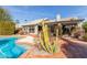 Stunning pool area features beautiful cacti, lush landscaping, and a serene backyard at 10337 E Michigan Ave, Sun Lakes, AZ 85248