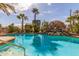 Inviting pool featuring rock waterfall feature and lush desert landscaping for a serene backyard oasis at 10337 E Michigan Ave, Sun Lakes, AZ 85248