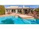 Inviting backyard pool, patio, and lush landscaping create a perfect outdoor oasis at 10337 E Michigan Ave, Sun Lakes, AZ 85248