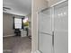 Bright bathroom featuring glass shower and tv in the next room at 10428 S 54Th Ln, Laveen, AZ 85339