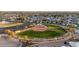 Aerial view of a well-maintained baseball field and a parking lot in a residential area at 10511 W Edgewood Dr, Sun City, AZ 85351